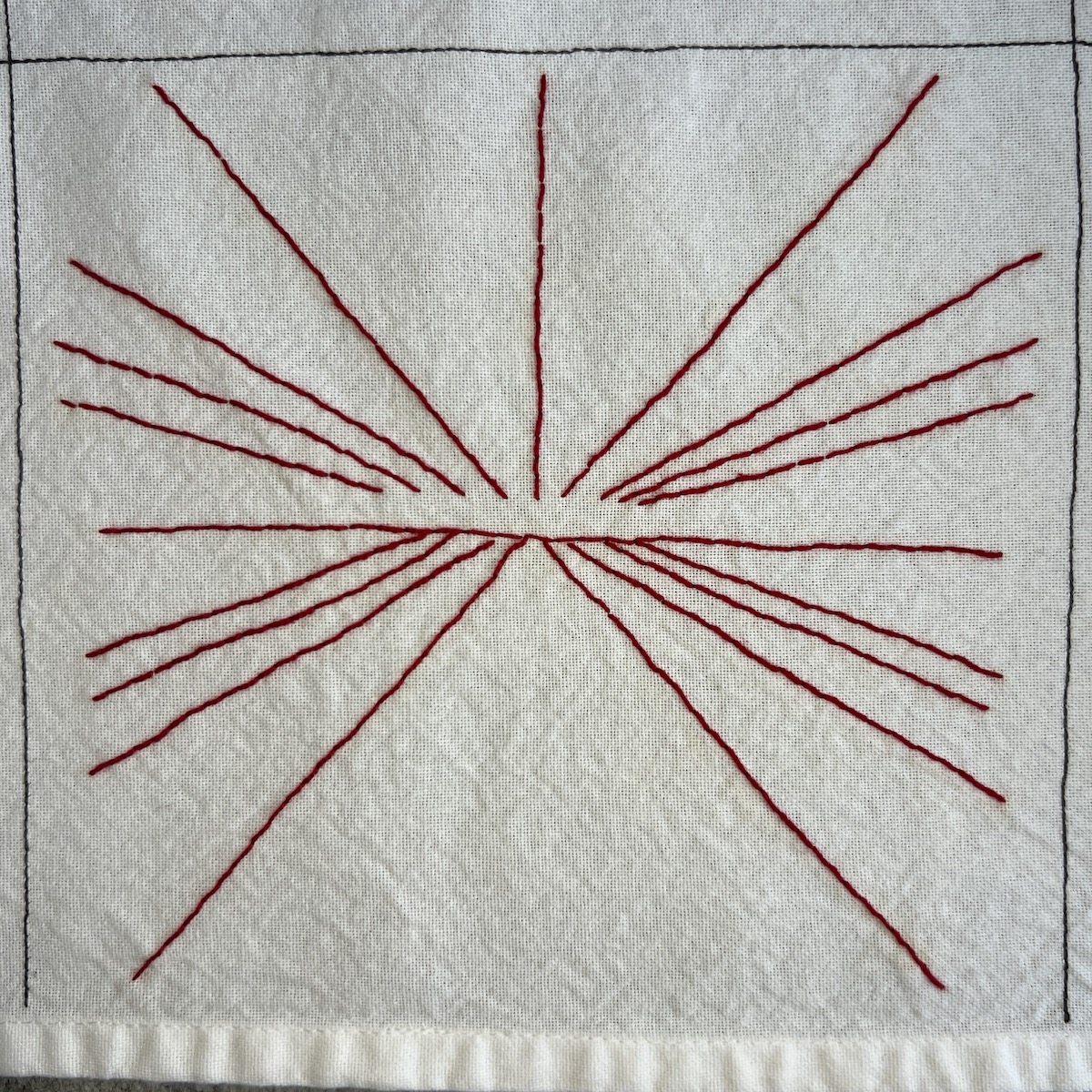 Overhead photo of white fabric 8”x8” square. Red thread is embroidered in diagonal lines that radiate out from a horizon.