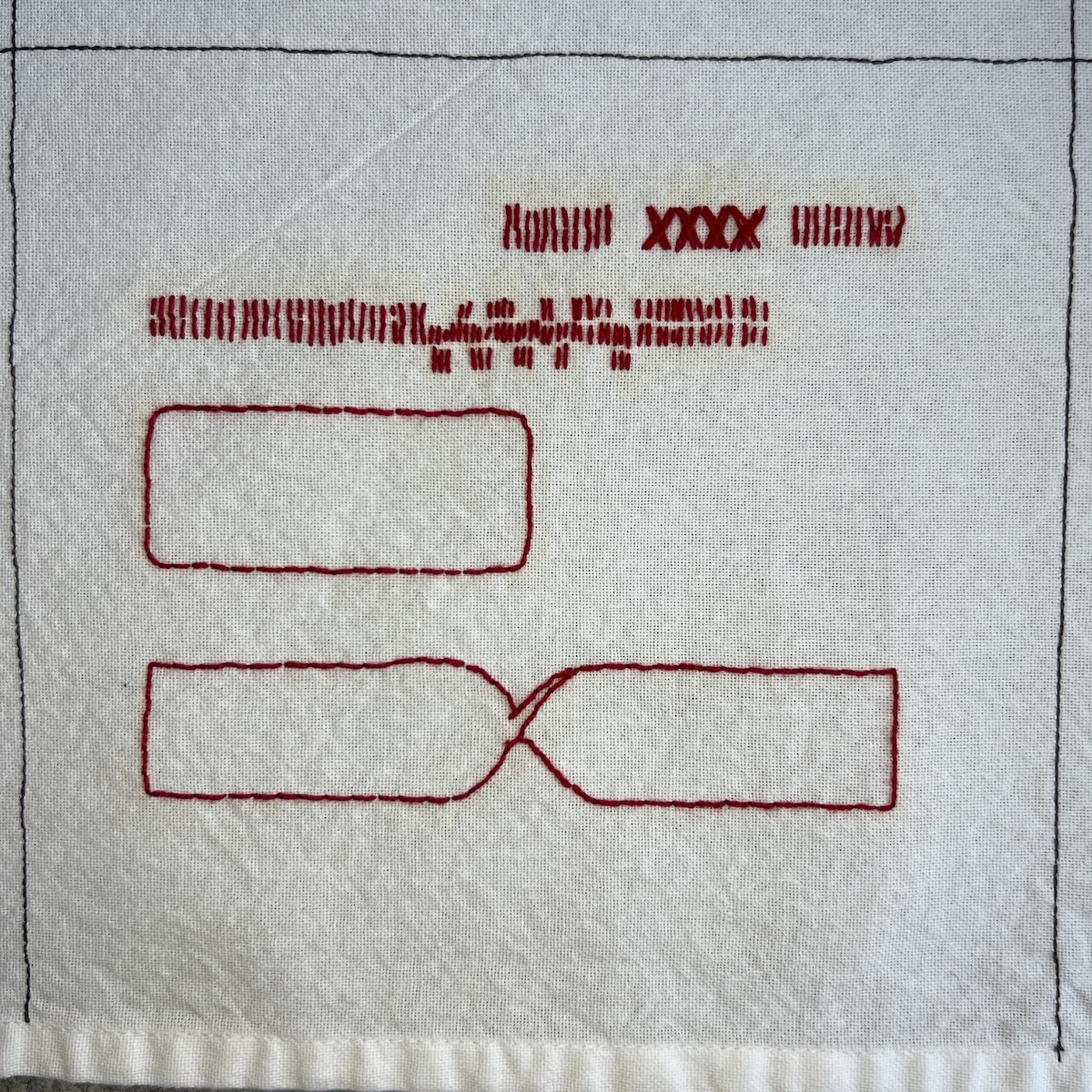 Overhead photo of white fabric 8”x8” square, with red embroidered lines. At the bottom of the square is a ribbon shape that looks like it’s twisted in the middle. Above that is a rounded rectangle, a horizontal line of short vertical red stitches, and another short row of vertical stitches and Xs.